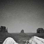 Self-portrait photo of Sean Tomlinson in front of the buttes of Monument Valley.